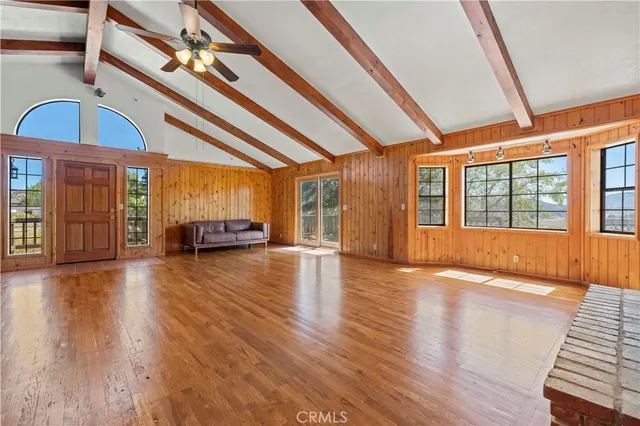 a view of an entryway with wooden floor and door