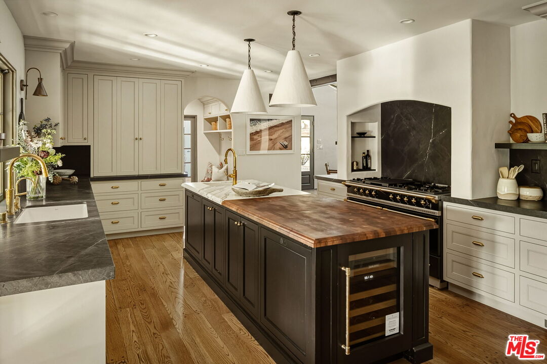 1744 Reedvale Lane Los Angeles, CA 90049 - Photo 11 of 30 a kitchen with stainless steel appliances granite countertop a stove and a wooden floors