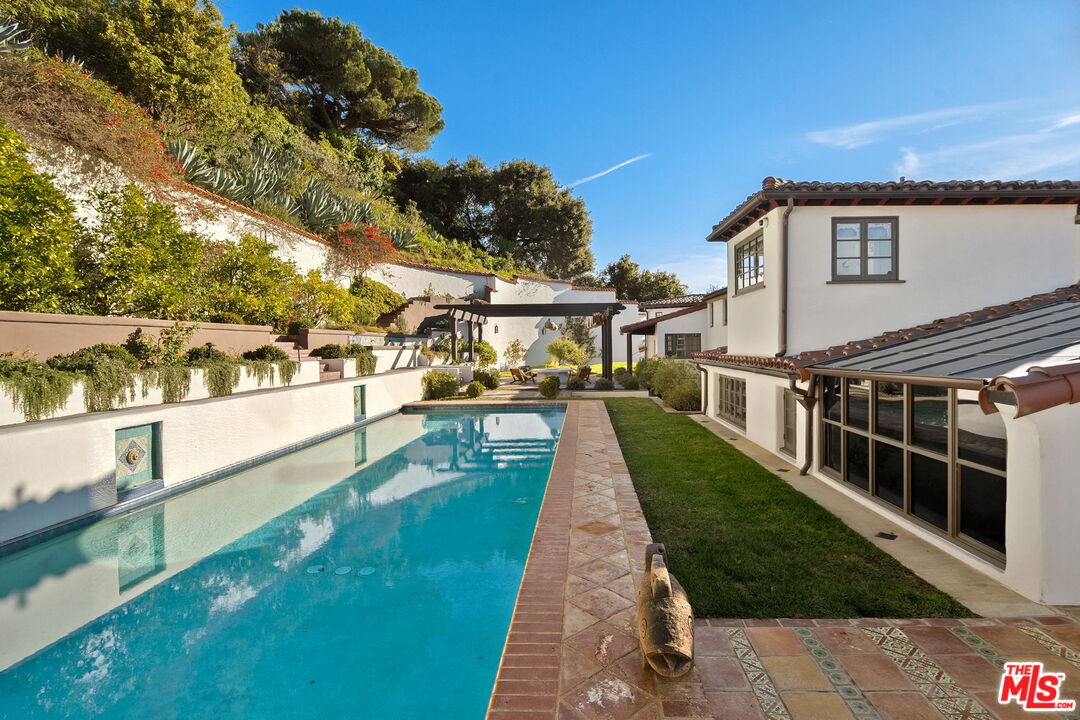 1744 Reedvale Lane Los Angeles, CA 90049 - Photo 15 of 30 a view of a swimming pool with a patio