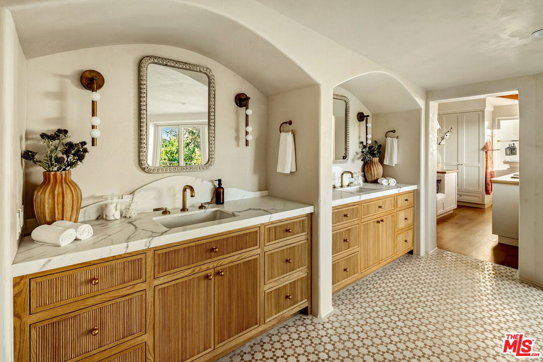 1744 Reedvale Lane Los Angeles, CA 90049 - Photo 19 of 30 a spacious bathroom with a double vanity sink a mirror and a shower