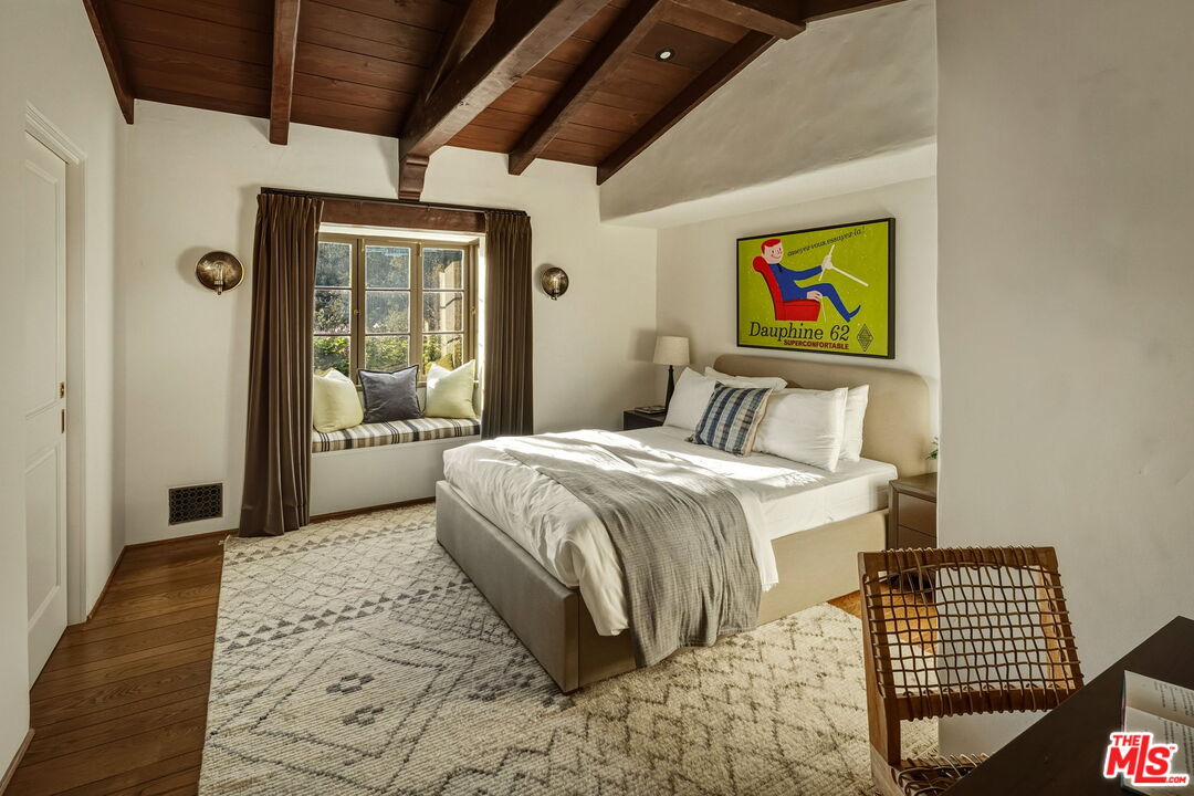 1744 Reedvale Lane Los Angeles, CA 90049 - Photo 23 of 30 a bedroom with a bed and wooden floor