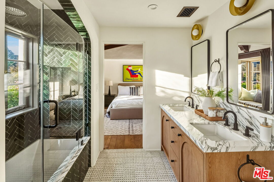 1744 Reedvale Lane Los Angeles, CA 90049 - Photo 24 of 30 a en suite bathroom with a granite countertop tub a double vanity sink a mirror and shower