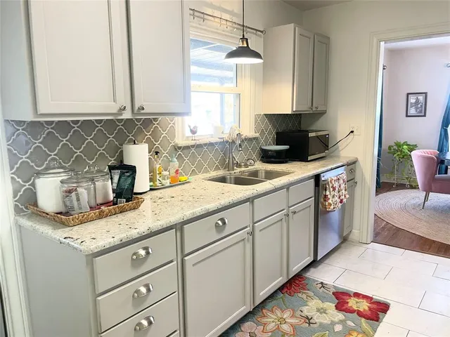 a kitchen with stainless steel appliances granite countertop a sink stove and cabinets
