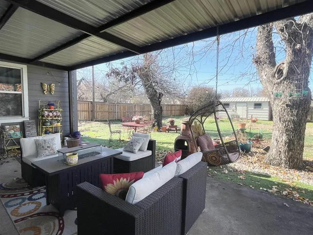 a view of a house with a small yard and floor to ceiling window