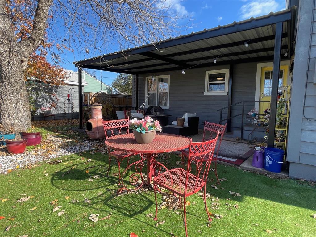 1208 Carolina Street Graham, TX 76450 - Photo 22 of 25 a patio with table and chairs and potted plants