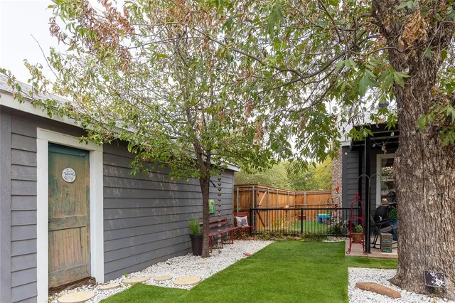a view of a house with backyard and chairs