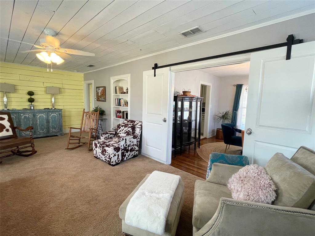 1208 Carolina Street Graham, TX 76450 - Photo 3 of 25 a living room with furniture and a chandelier