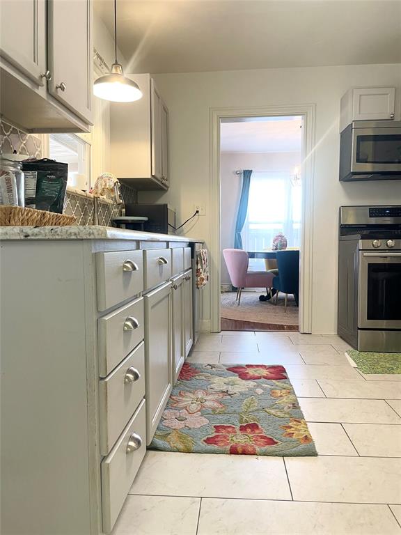 1208 Carolina Street Graham, TX 76450 - Photo 10 of 25 a living room with stainless steel appliances kitchen island granite countertop a sink and a stove
