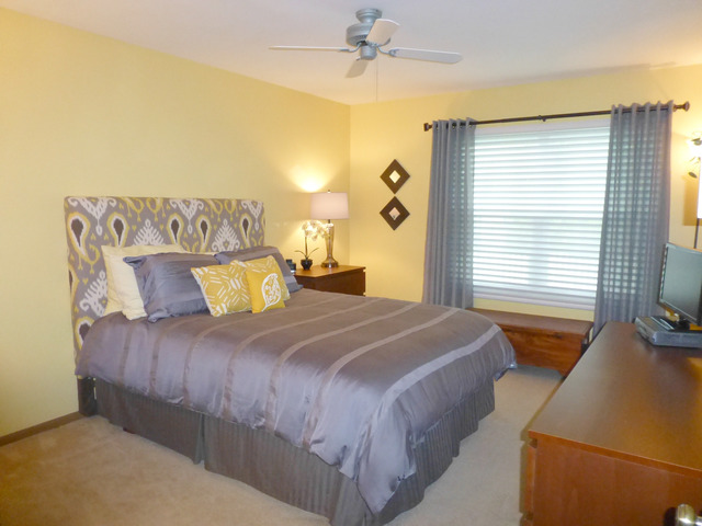 1726 Ranchview Drive Naperville, IL 60565 - Photo 9 of 14 a bedroom with a large bed and a chandelier