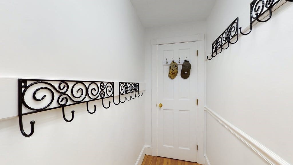 16 Chiltern Road Weston, MA 02493 - Photo 9 of 35 a white wall with rack on the wall