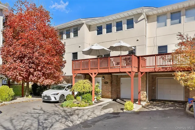 a front view of a building with garage and glass windows