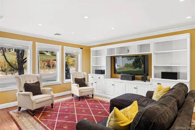 a living room with furniture large window and a flat screen tv