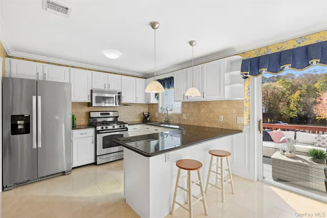 a kitchen with granite countertop a counter space a sink appliances and cabinets