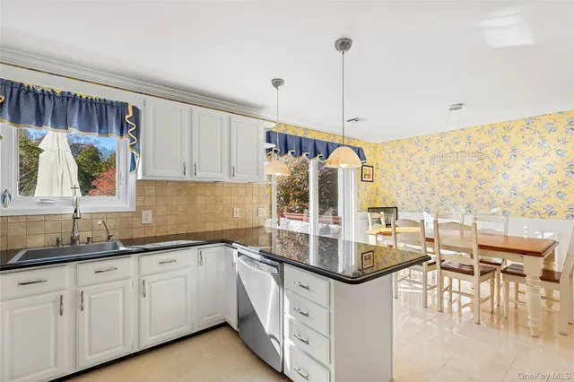 a kitchen with stainless steel appliances granite countertop a stove and cabinets