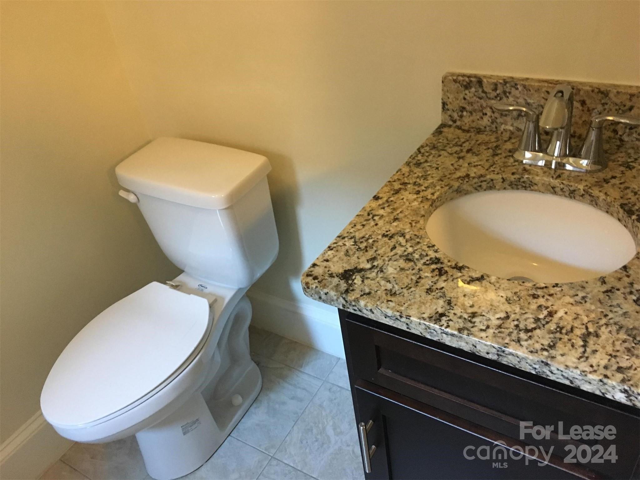 1708 Dilworth Road West, Unit 8 Charlotte, NC 28203 - Photo 12 of 15 a bathroom with a toilet sink and mirror