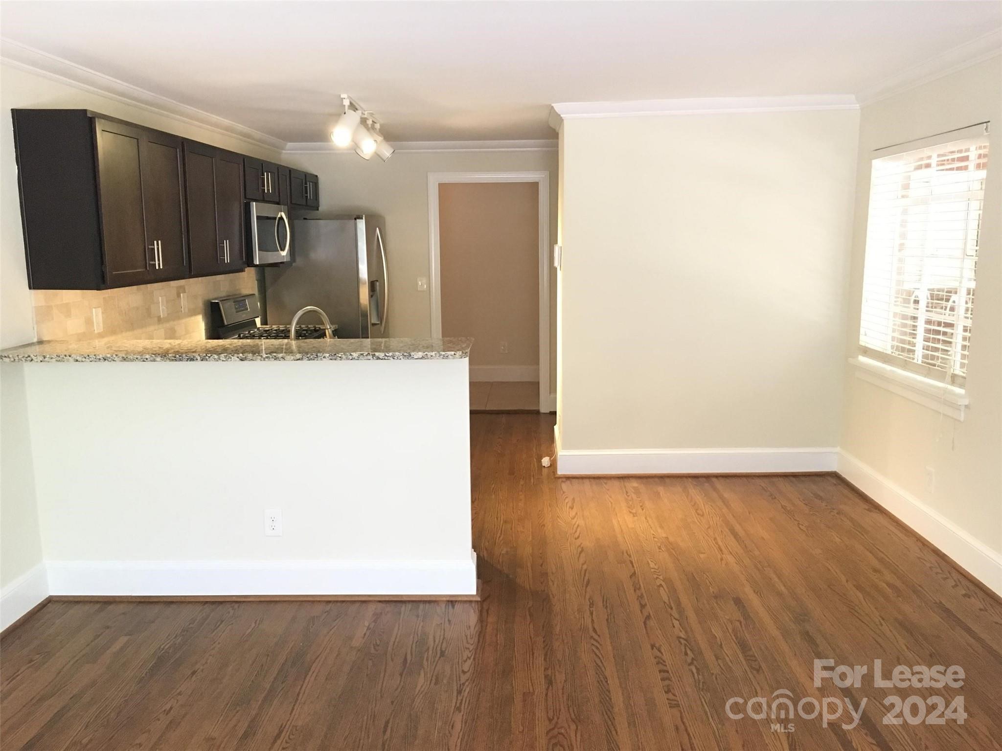 1708 Dilworth Road West, Unit 8 Charlotte, NC 28203 - Photo 4 of 15 a view of a kitchen with wooden floor and a window