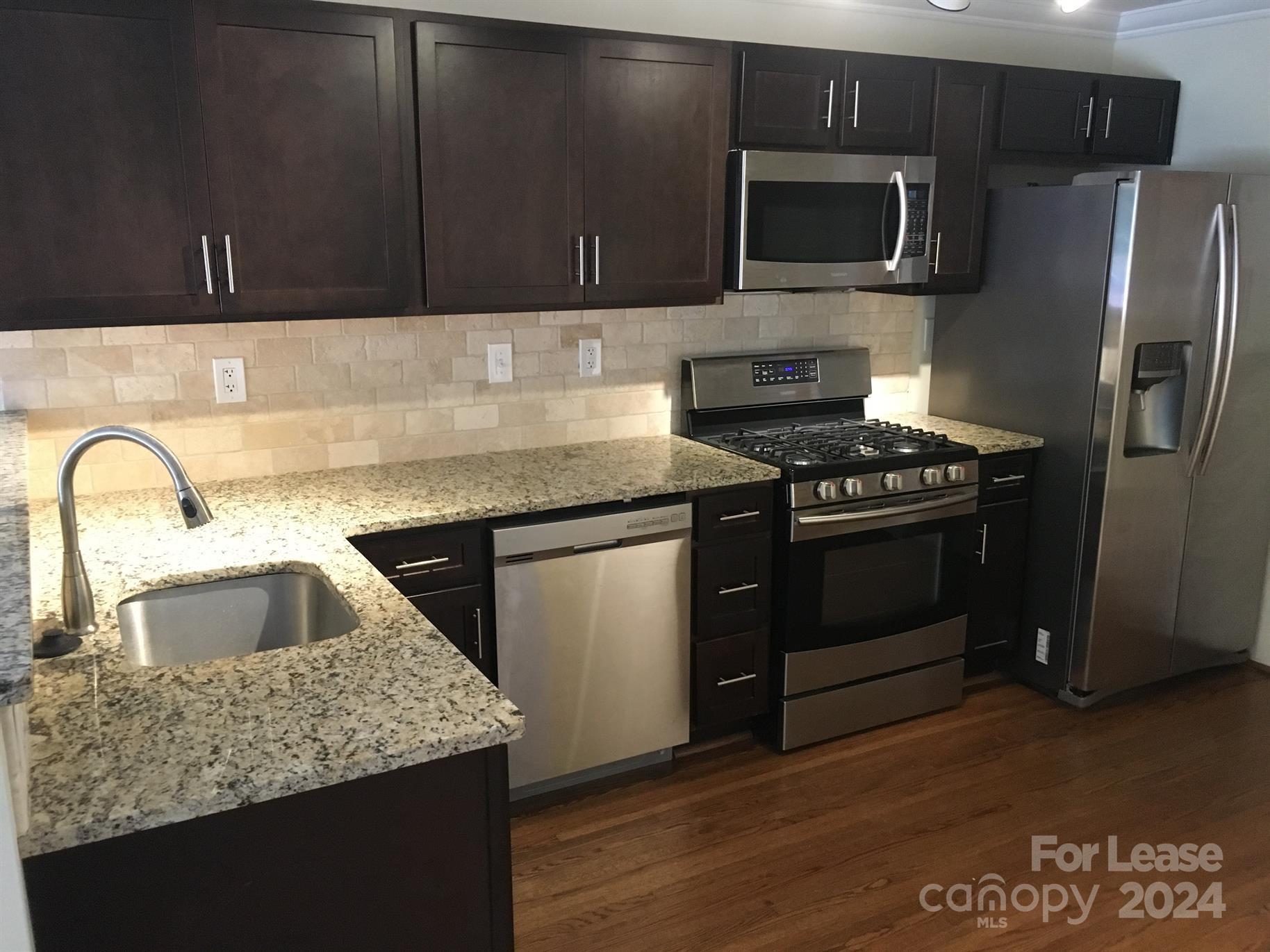 1708 Dilworth Road West, Unit 8 Charlotte, NC 28203 - Photo 5 of 15 a kitchen with granite countertop a sink and a stove