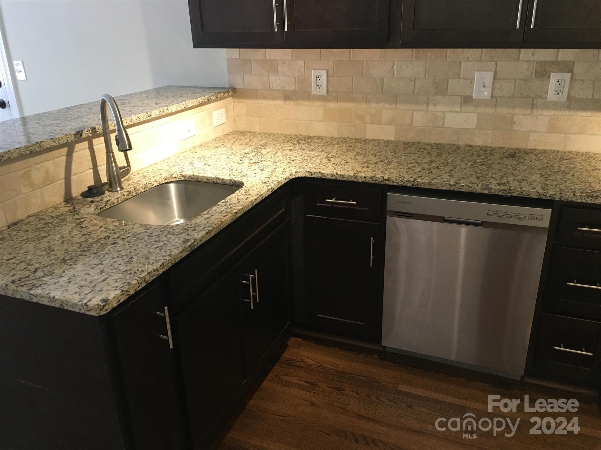 1708 Dilworth Road West, Unit 8 Charlotte, NC 28203 - Photo 6 of 15 a kitchen with granite countertop a sink and a wooden floor
