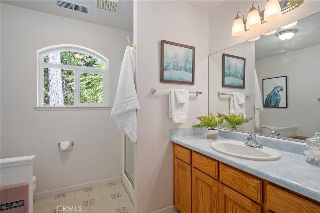 5245 Headwaters Road Forest Ranch, CA 95942 - Photo 21 of 47 a bathroom with a granite countertop sink toilet and a mirror