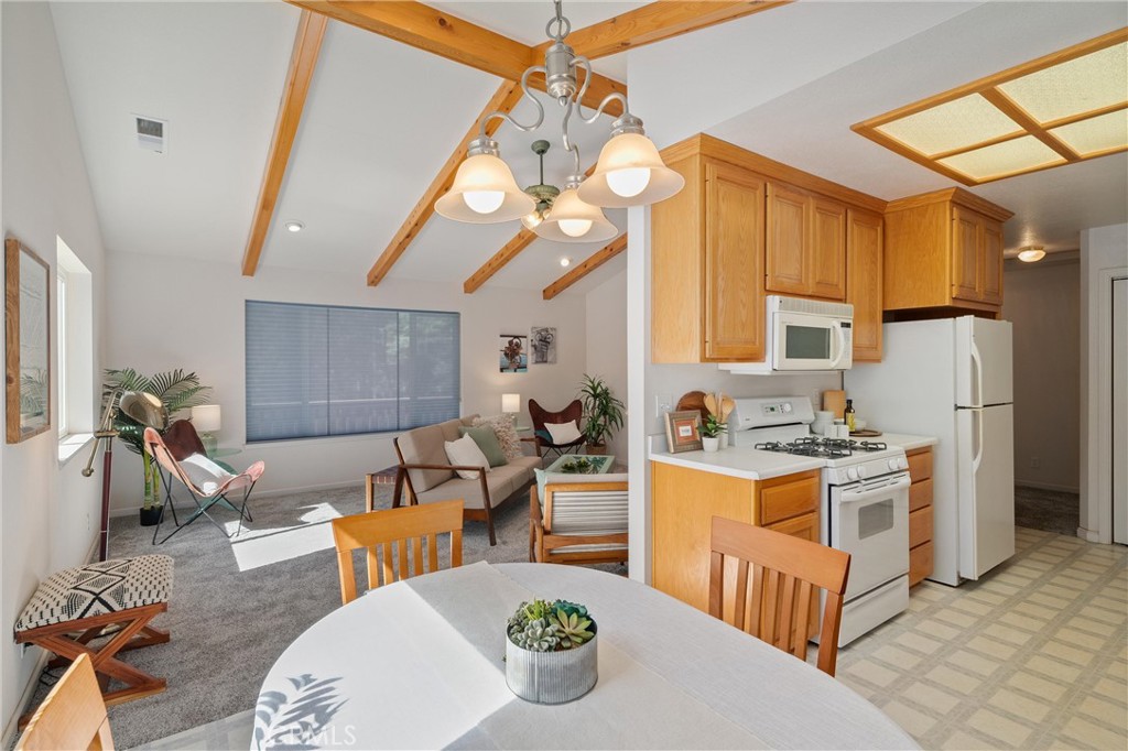 5245 Headwaters Road Forest Ranch, CA 95942 - Photo 3 of 47 a kitchen with stainless steel appliances kitchen island granite countertop a table chairs in it and a window