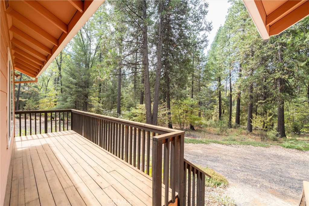 5245 Headwaters Road Forest Ranch, CA 95942 - Photo 8 of 47 a balcony with wooden floor and trees