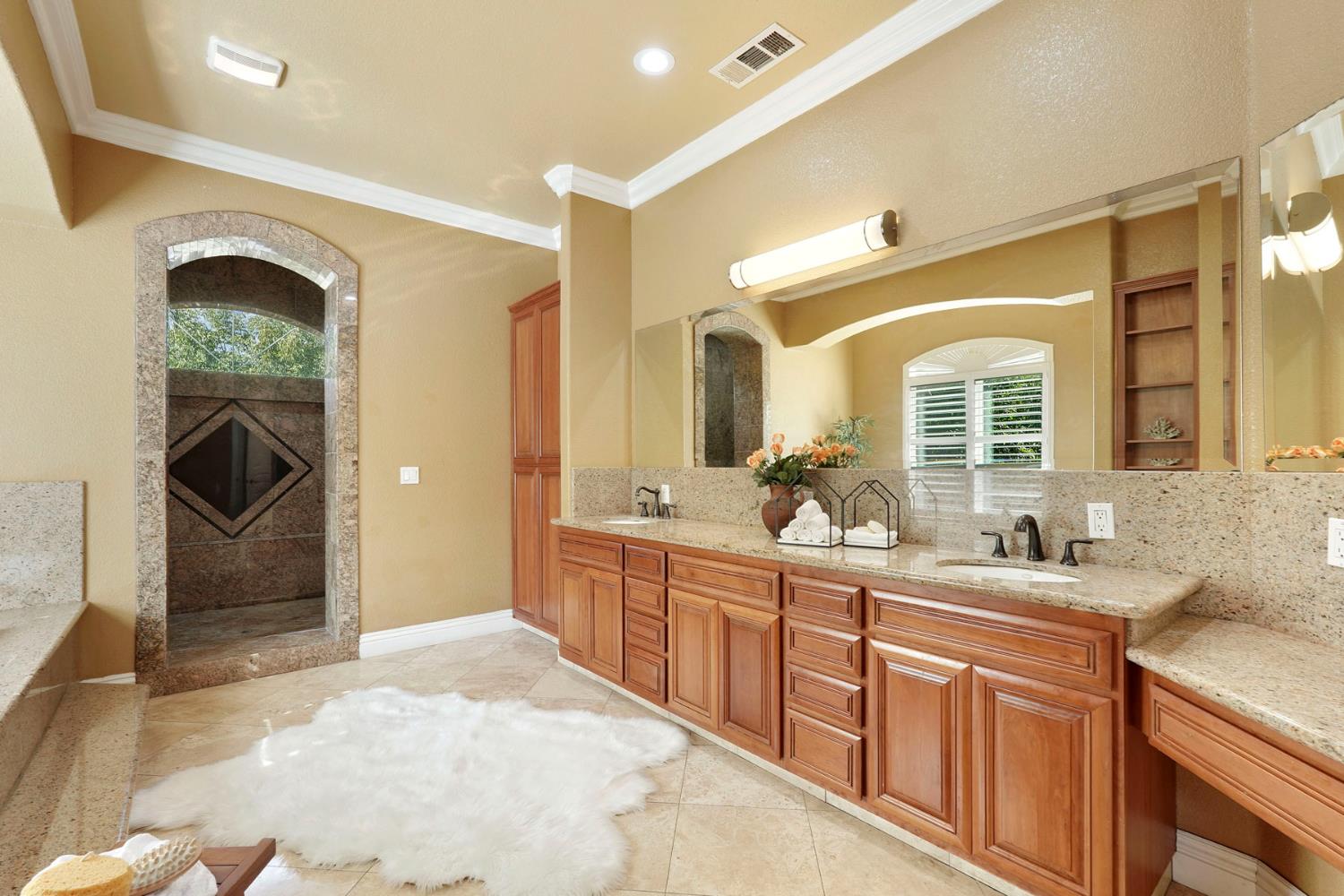 7306 Van Allen Road Stockton, CA 95215 - Photo 40 of 87 a spacious bathroom with a sink a mirror and a shower