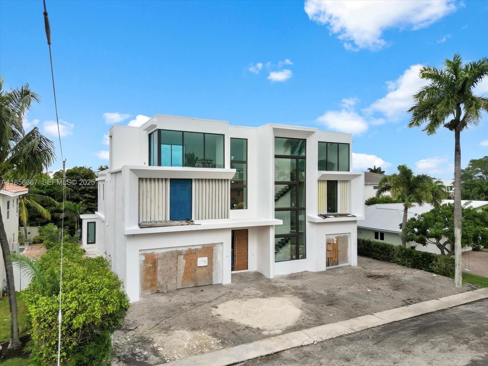 365 Northeast 3rd Street Boca Raton, FL 33432 - Photo 2 of 8 a front view of a house with a garden