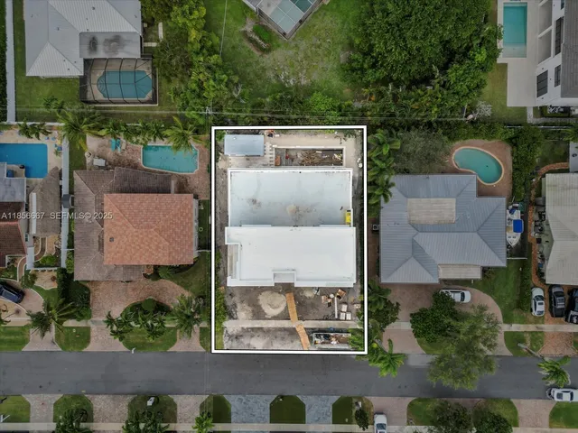 an aerial view of a house with garden space and street view