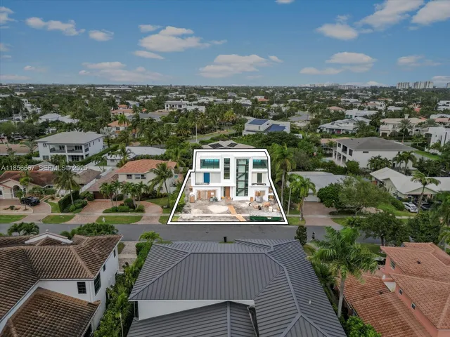 an aerial view of a house with a yard