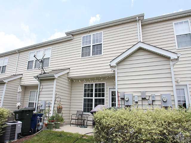 7813 Silverthread Lane Raleigh, NC 27617 - Photo 12 of 25 a front view of a house with garden