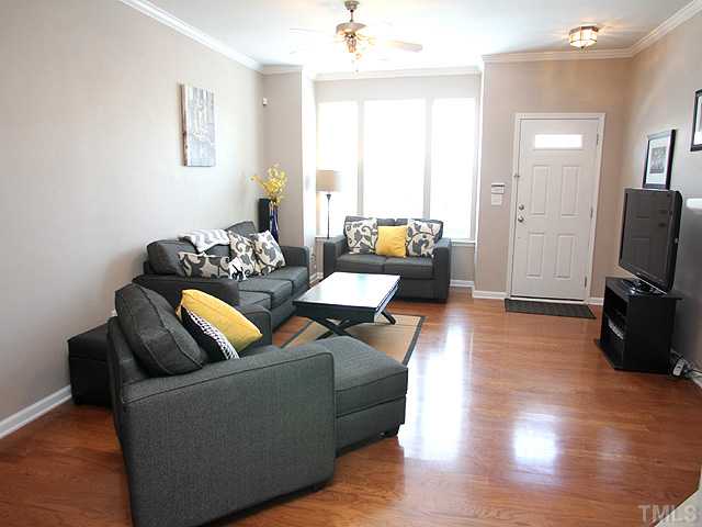 7813 Silverthread Lane Raleigh, NC 27617 - Photo 3 of 25 a living room with furniture and a flat screen tv