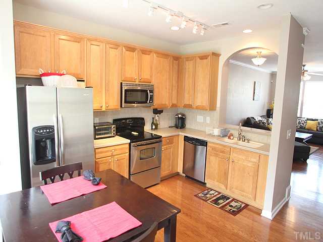 7813 Silverthread Lane Raleigh, NC 27617 - Photo 4 of 25 a kitchen with stainless steel appliances granite countertop a refrigerator stove microwave and sink