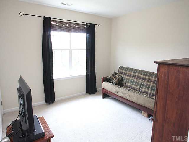 7813 Silverthread Lane Raleigh, NC 27617 - Photo 8 of 25 a living room with furniture and a window