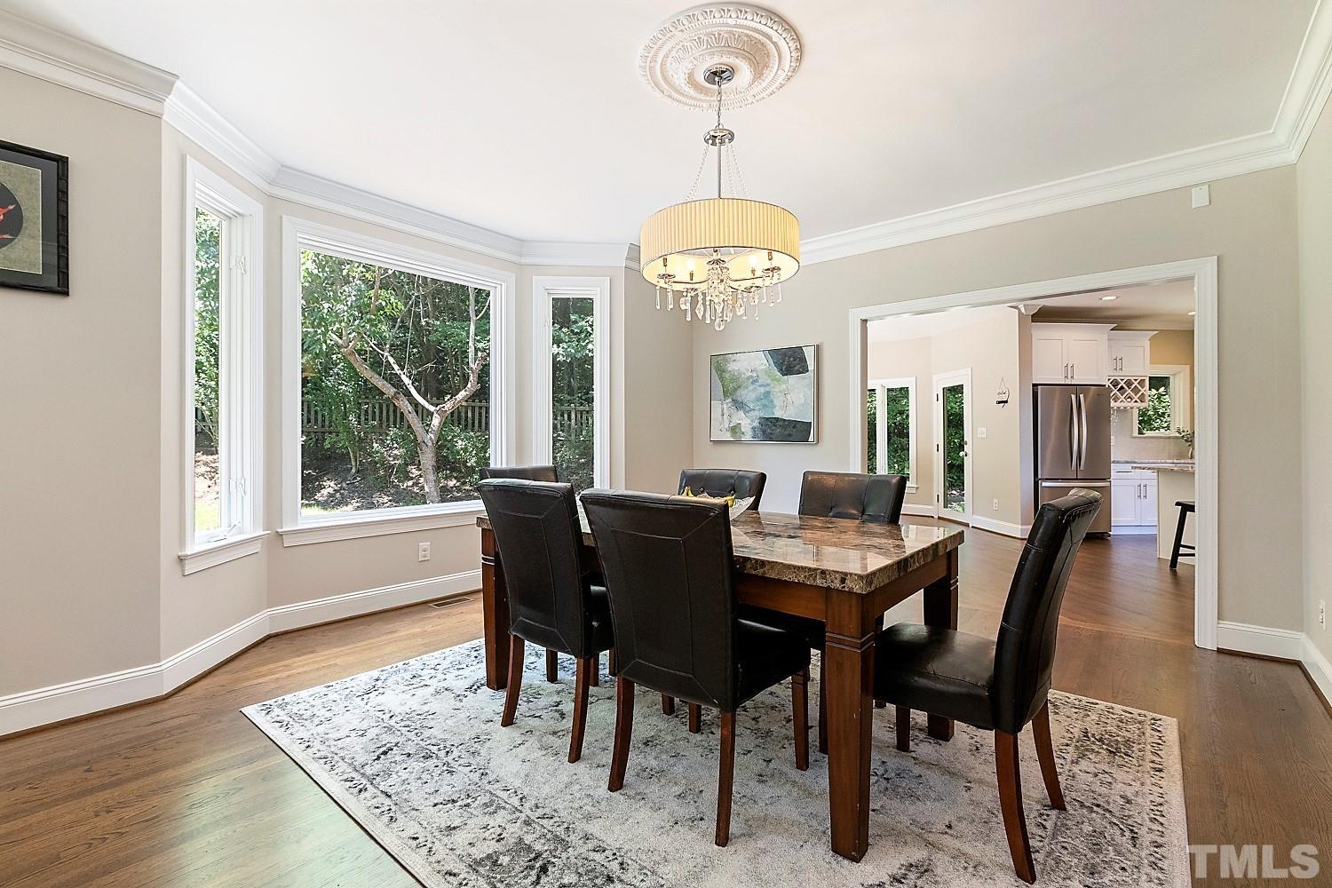 100 Greyfriars Lane Cary, NC 27518 - Photo 16 of 71 a view of a dining room with furniture window and wooden floor