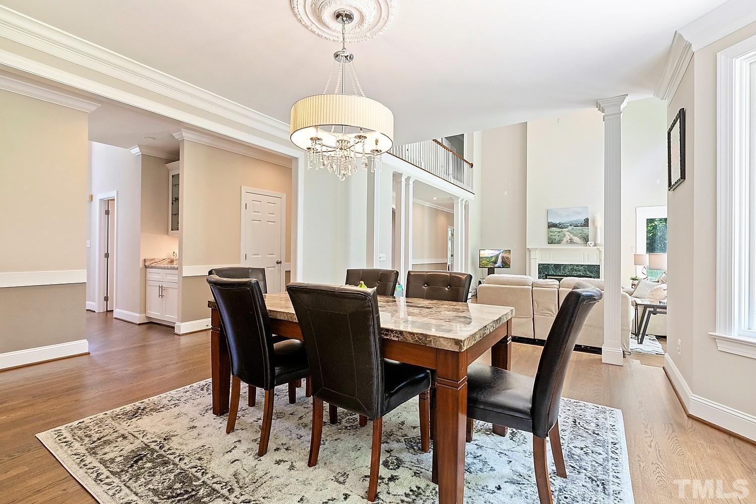 100 Greyfriars Lane Cary, NC 27518 - Photo 18 of 71 a view of a dining room with furniture window and wooden floor