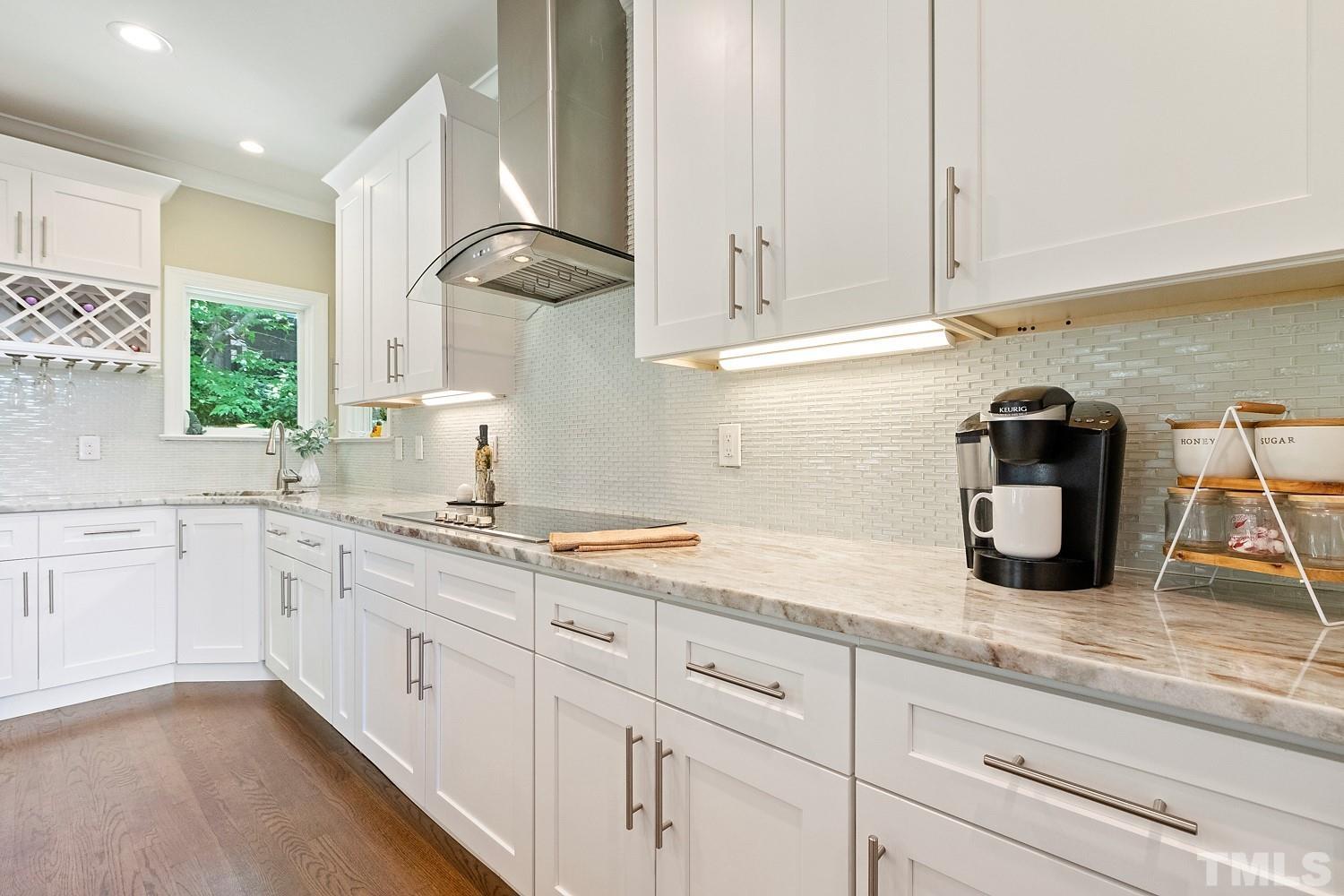 100 Greyfriars Lane Cary, NC 27518 - Photo 27 of 71 a kitchen with granite countertop white cabinets and white appliances