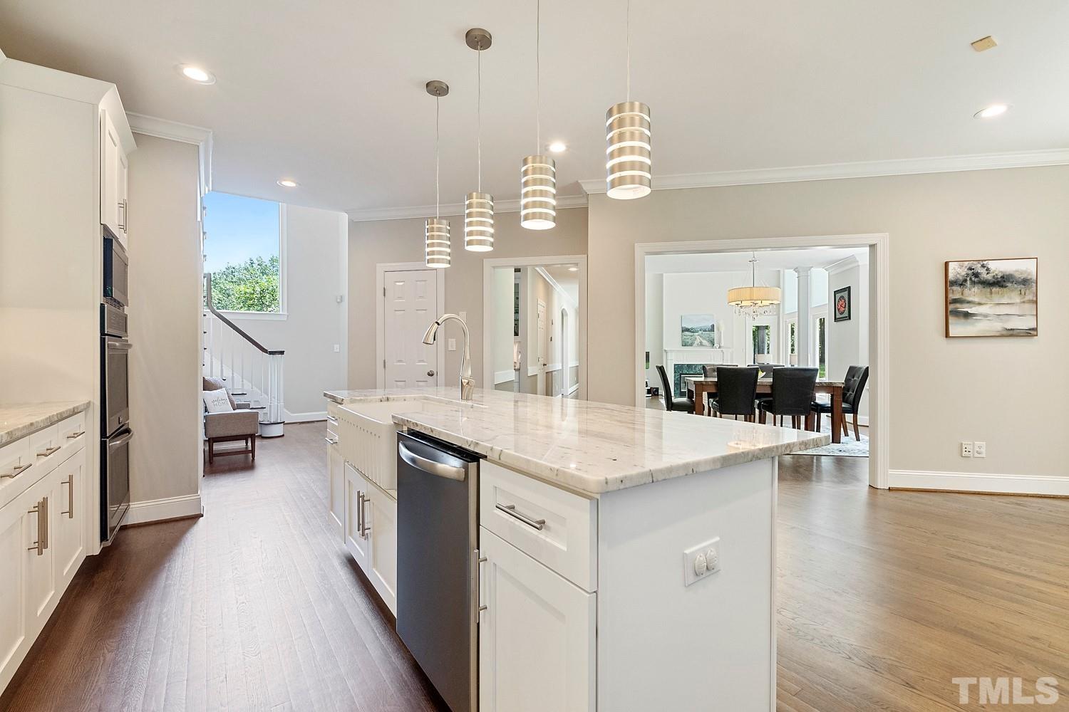 100 Greyfriars Lane Cary, NC 27518 - Photo 30 of 71 an open kitchen with a sink dishwasher a stove and a refrigerator with wooden floor