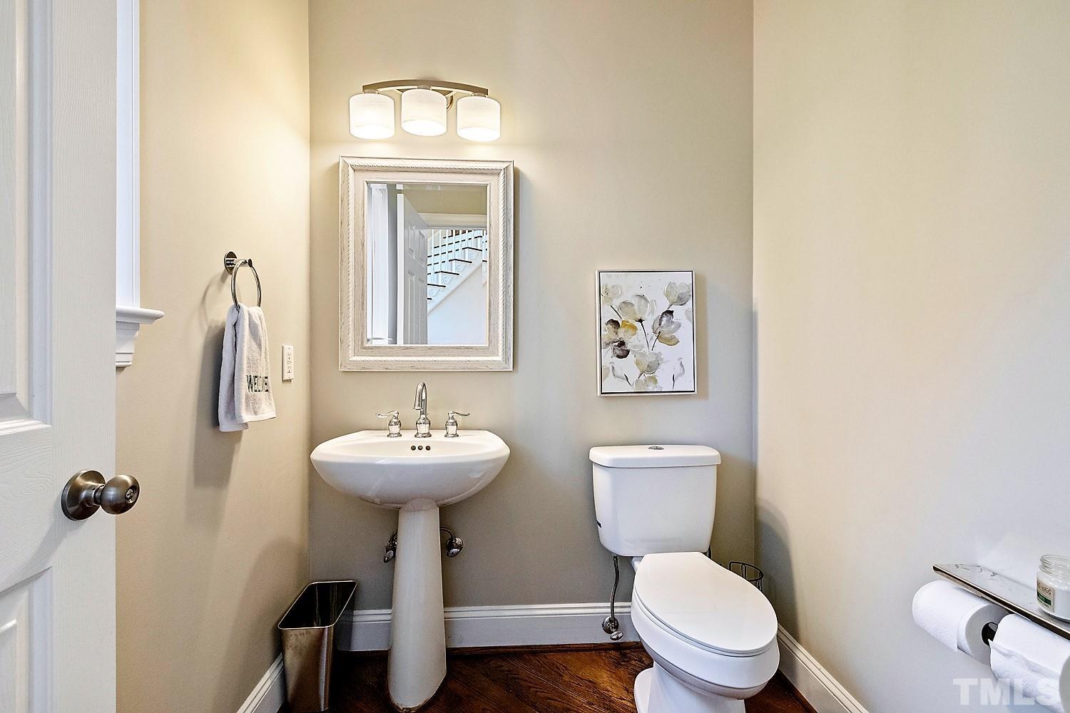 100 Greyfriars Lane Cary, NC 27518 - Photo 34 of 71 a bathroom with a toilet a sink and mirror