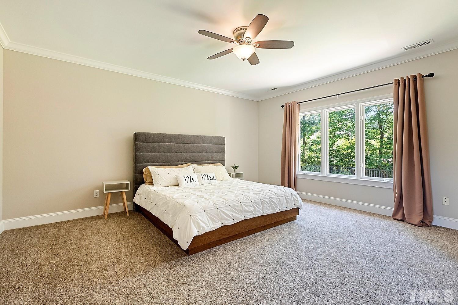 100 Greyfriars Lane Cary, NC 27518 - Photo 45 of 71 a bedroom with a bed and a large window