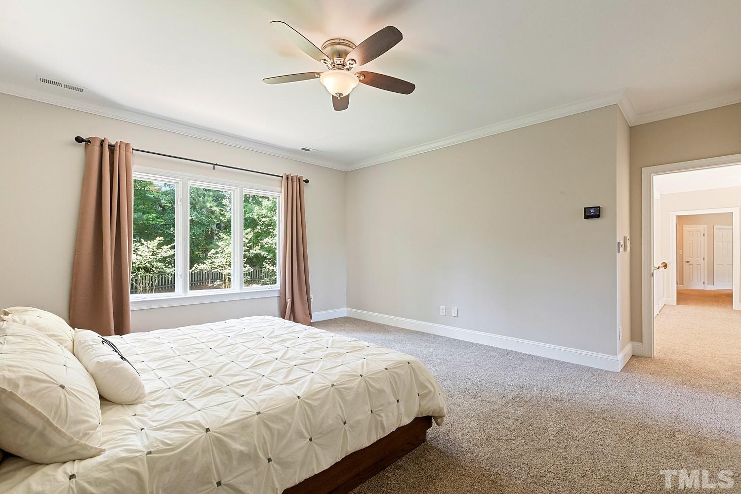 100 Greyfriars Lane Cary, NC 27518 - Photo 46 of 71 a bedroom with a bed and a chandelier