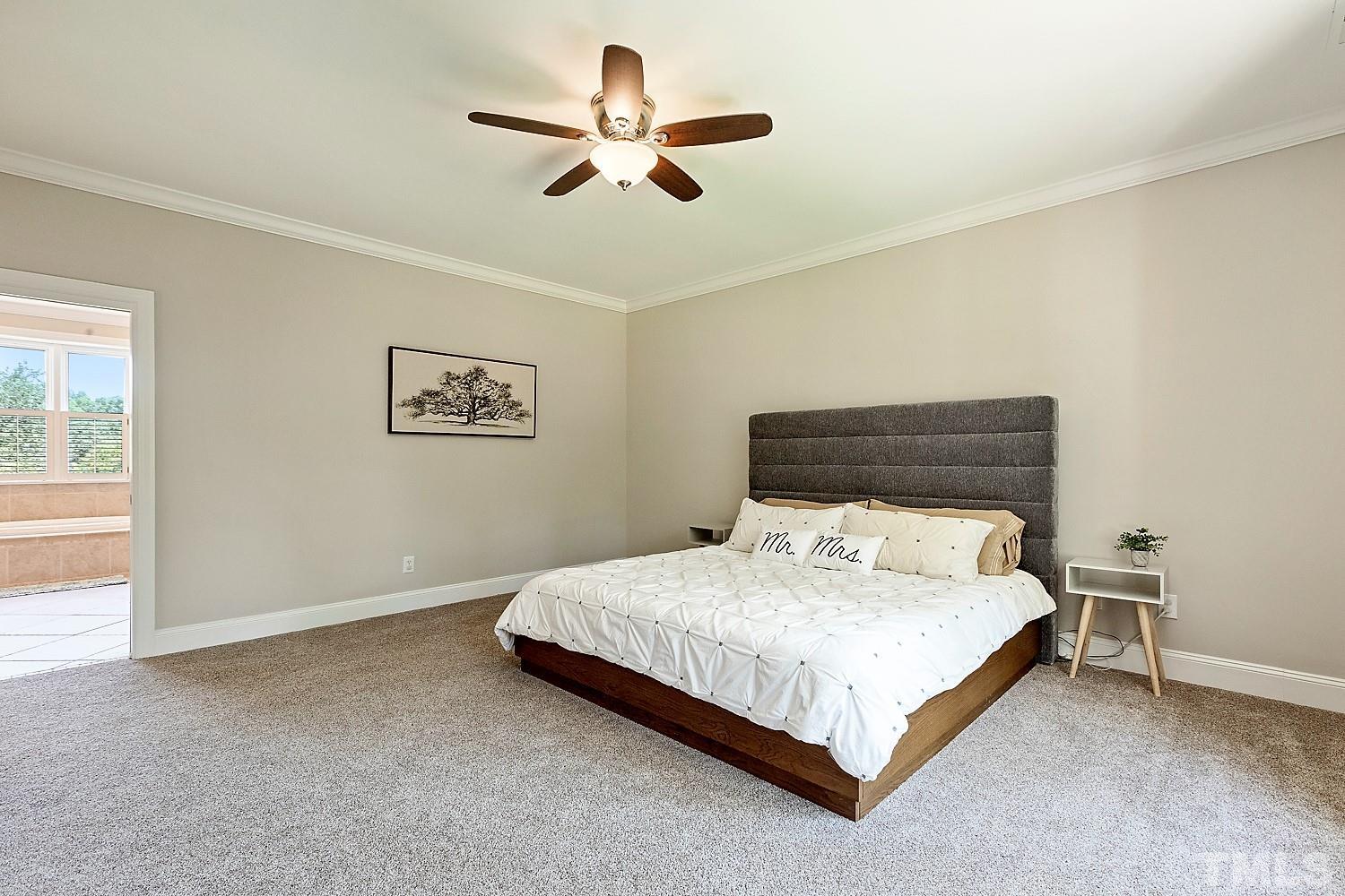 100 Greyfriars Lane Cary, NC 27518 - Photo 47 of 71 a bedroom with a bed and a ceiling fan