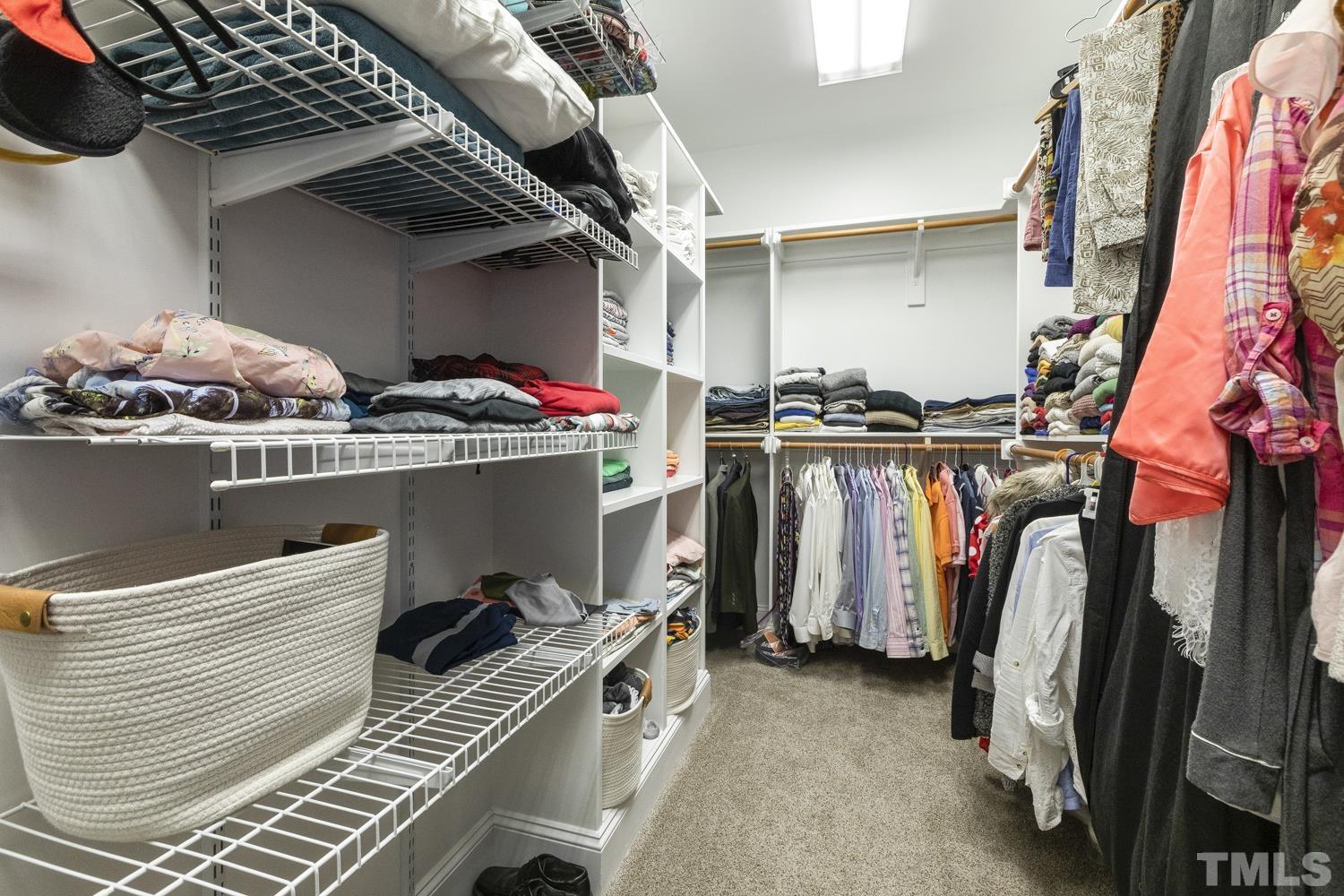 100 Greyfriars Lane Cary, NC 27518 - Photo 53 of 71 a view of walk in closet with clothes and shoes