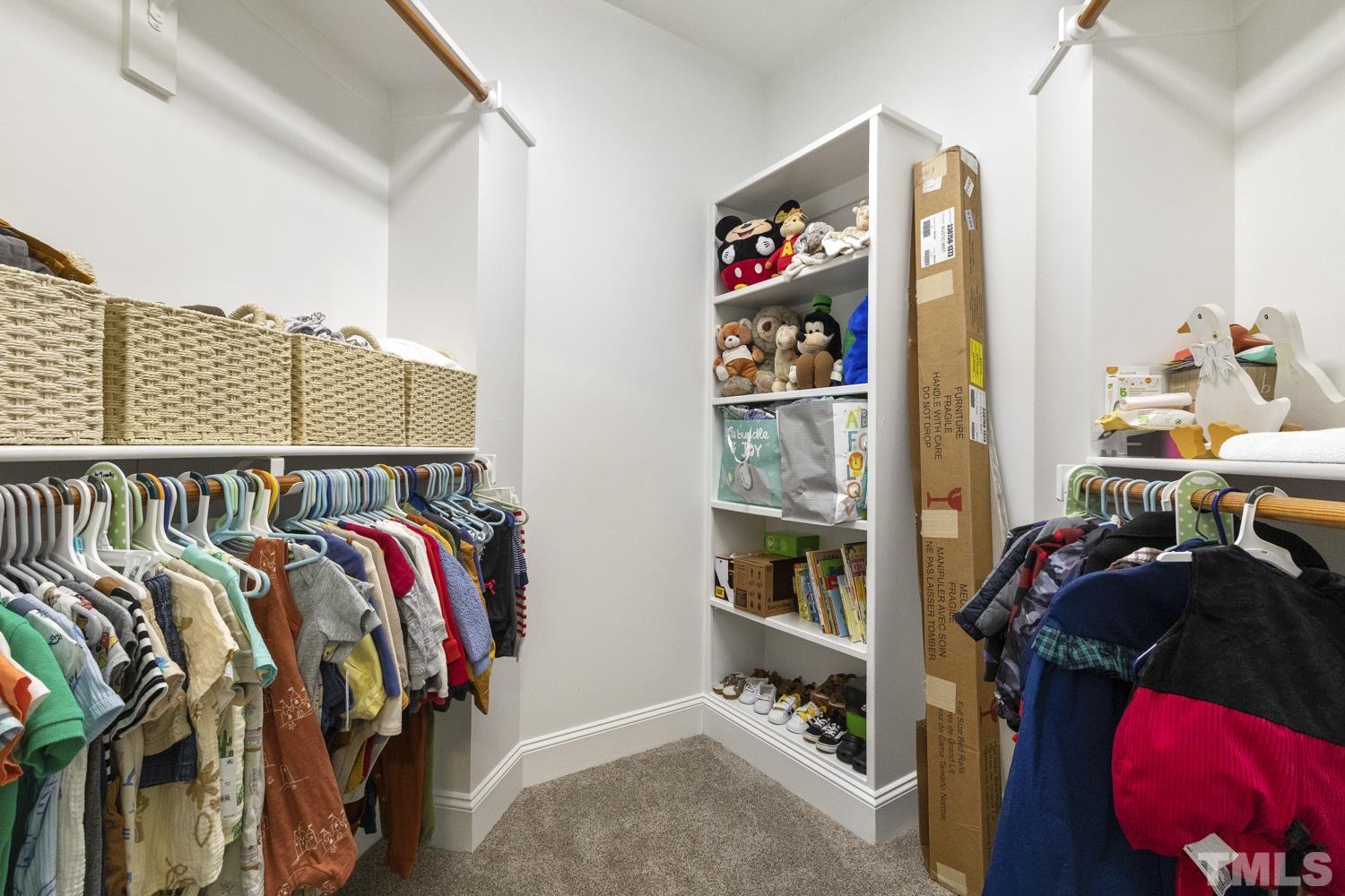 100 Greyfriars Lane Cary, NC 27518 - Photo 56 of 71 a view of walk in closet with clothes and shoes