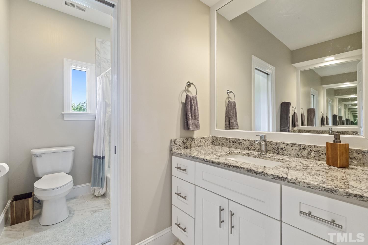 100 Greyfriars Lane Cary, NC 27518 - Photo 59 of 71 a bathroom with a granite countertop toilet sink and mirror