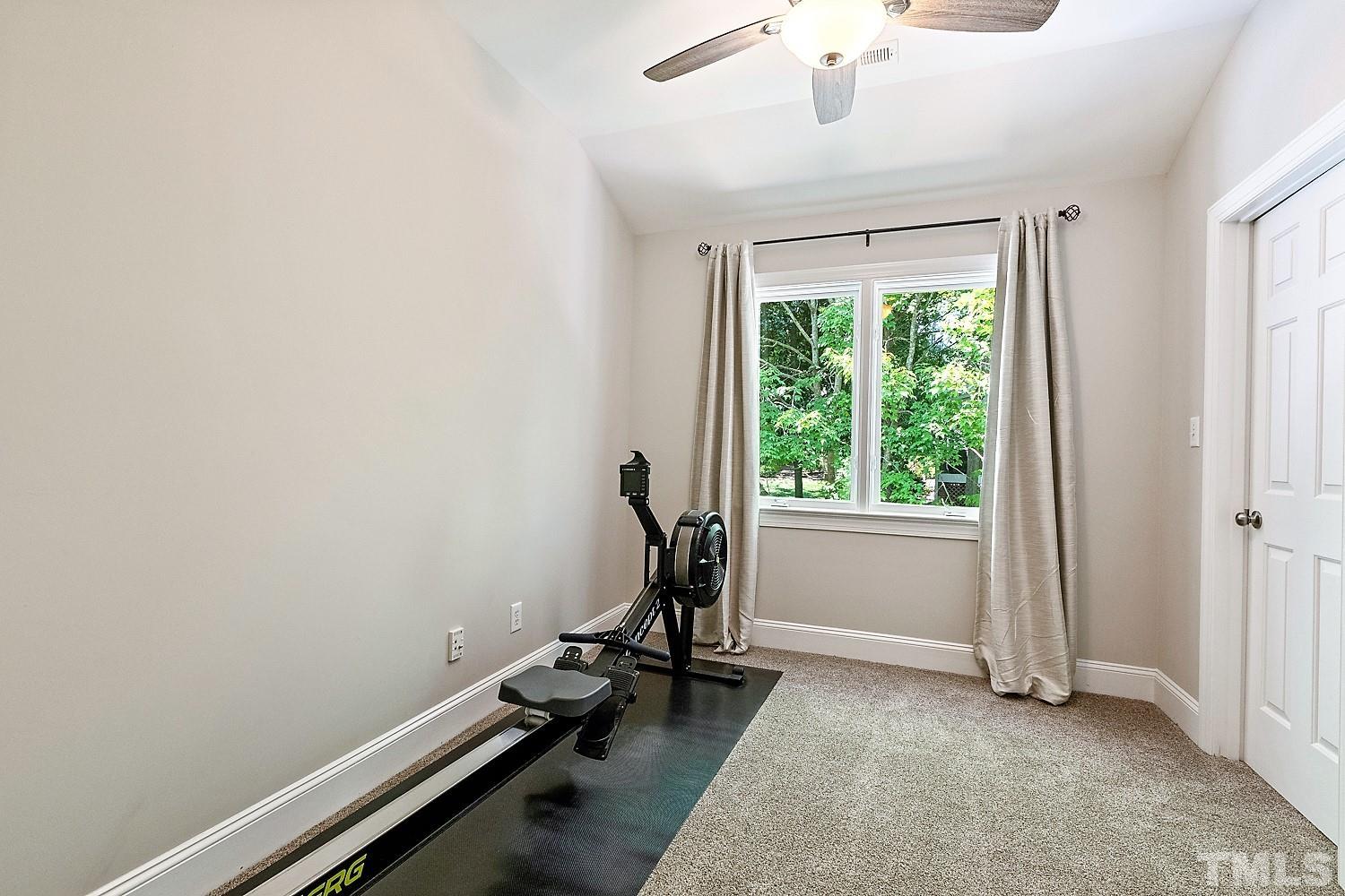 100 Greyfriars Lane Cary, NC 27518 - Photo 63 of 71 a room with gym equipment and a large window