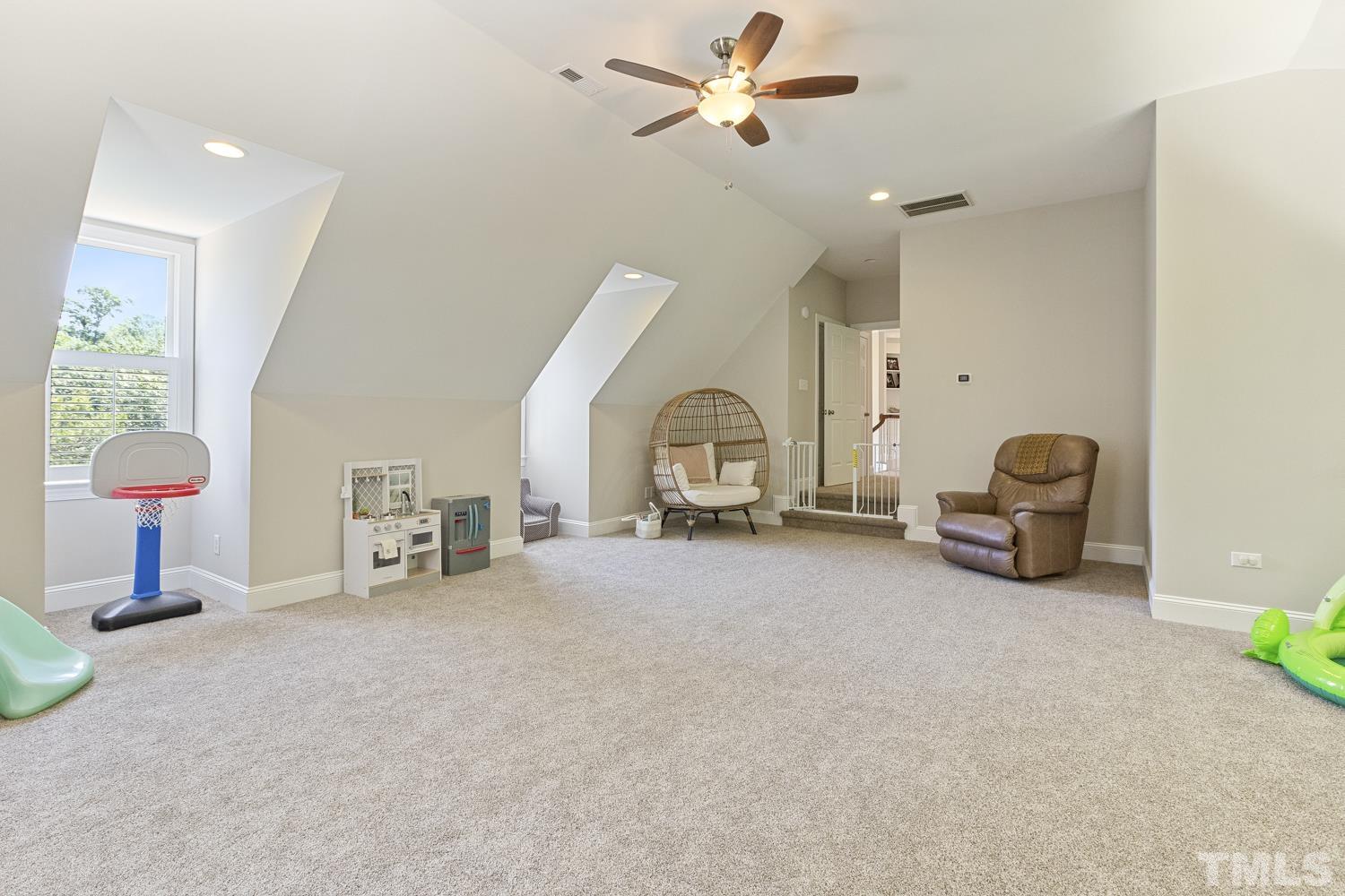 100 Greyfriars Lane Cary, NC 27518 - Photo 66 of 71 a living room with furniture a ceiling fan and a window