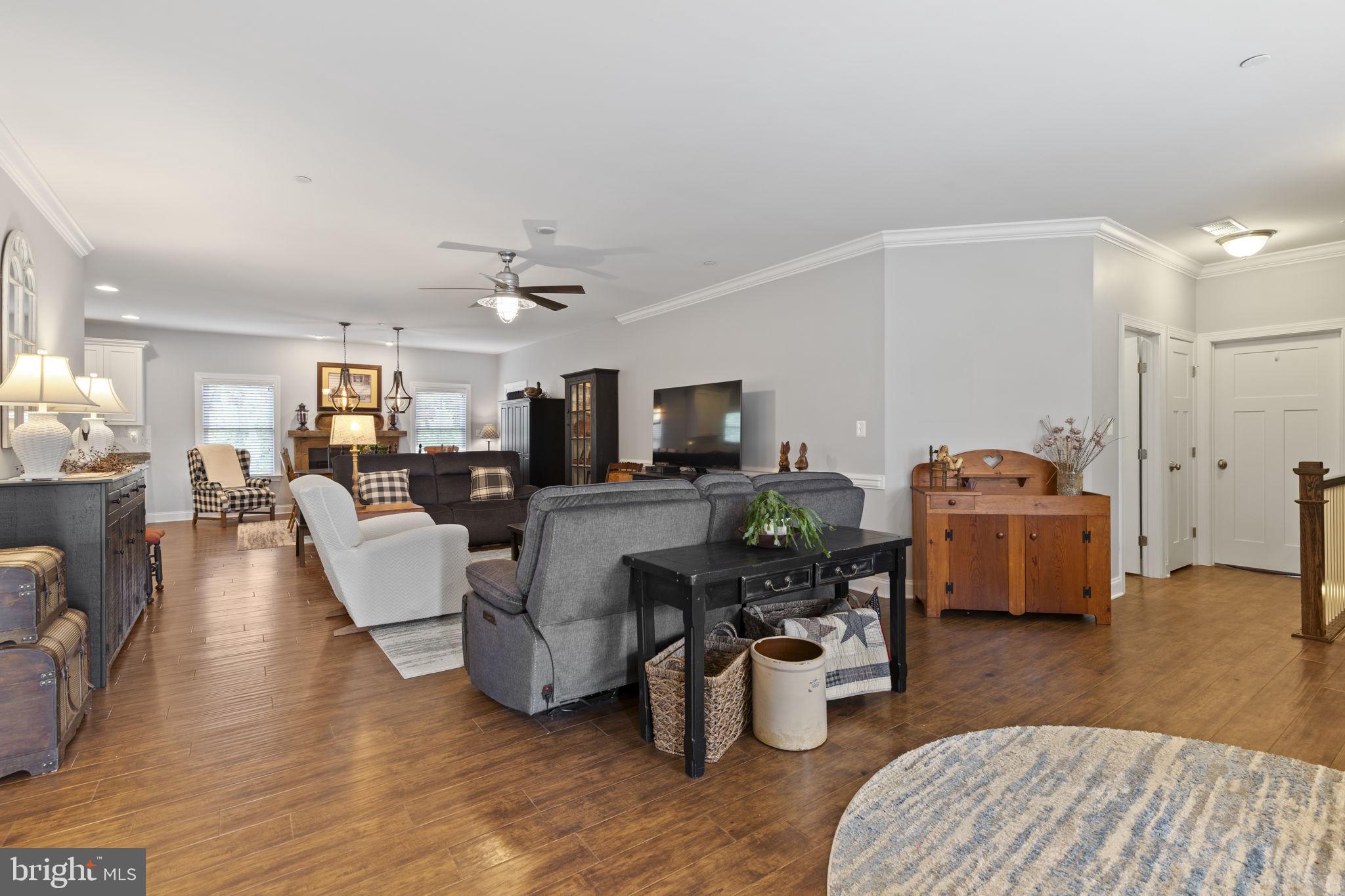 308 Rockspring Church Road Forest Hill, MD 21050 - Photo 12 of 79 a living room with furniture a wooden floor and a chandelier