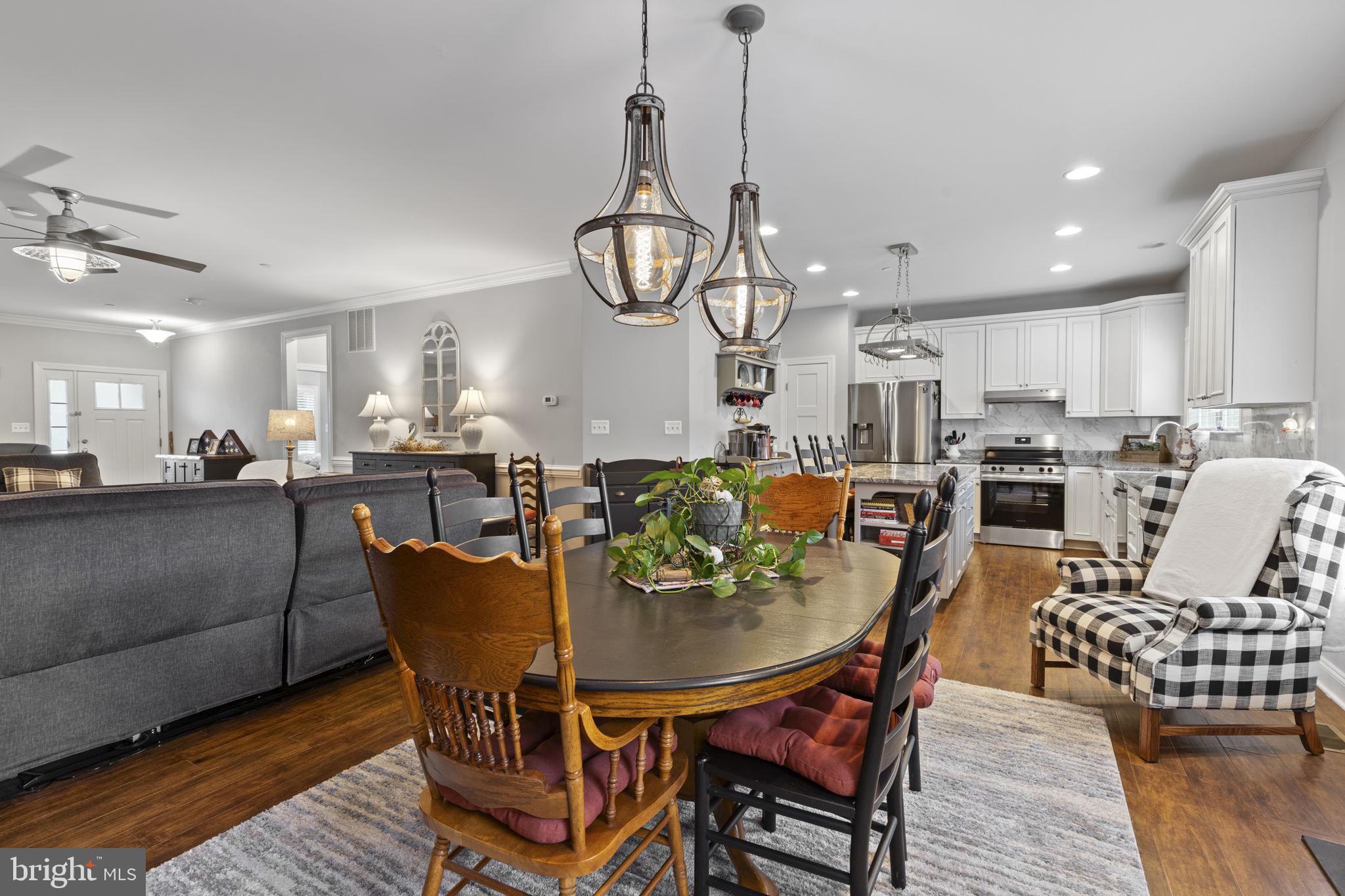 308 Rockspring Church Road Forest Hill, MD 21050 - Photo 20 of 79 a view of a dining room and livingroom with furniture wooden floor a rug a chandelier