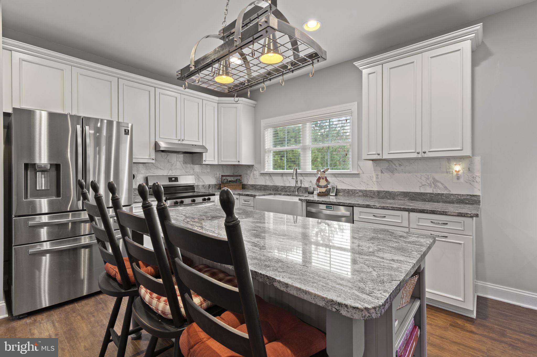 308 Rockspring Church Road Forest Hill, MD 21050 - Photo 23 of 79 a kitchen with granite countertop a center island stainless steel appliances cabinets and a window