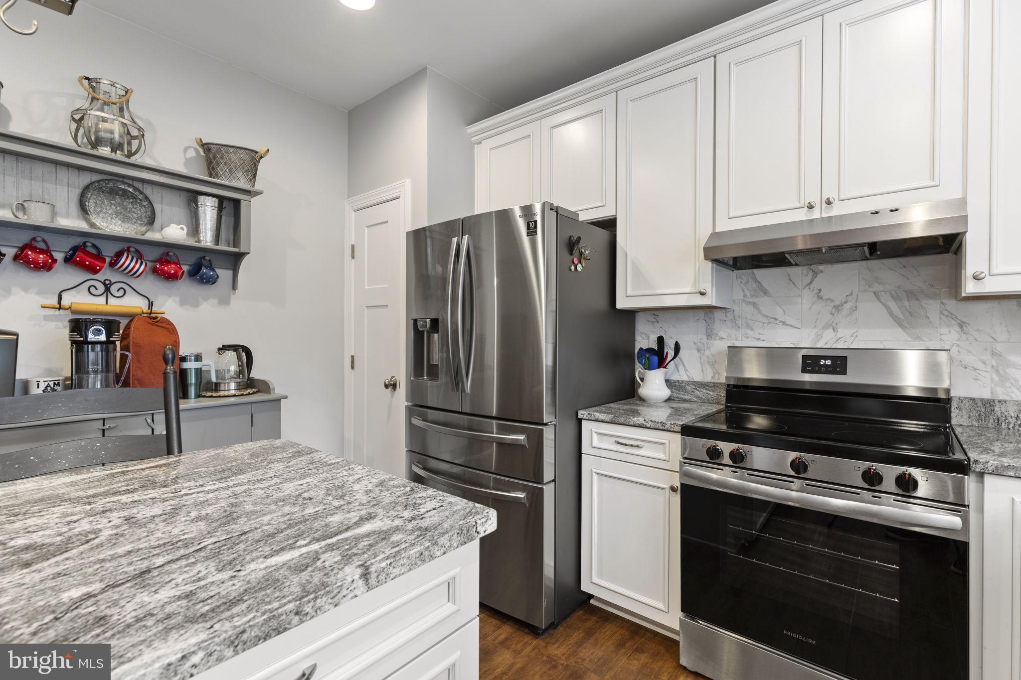 308 Rockspring Church Road Forest Hill, MD 21050 - Photo 25 of 79 a kitchen with stainless steel appliances granite countertop a stove and a refrigerator